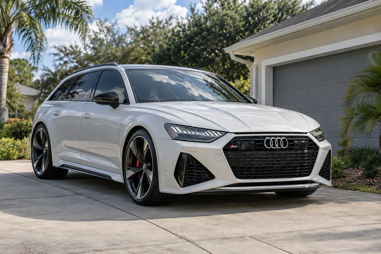 Pearl white Audi RS6 Avant with tinted windows at Dynamic Tinting Solution