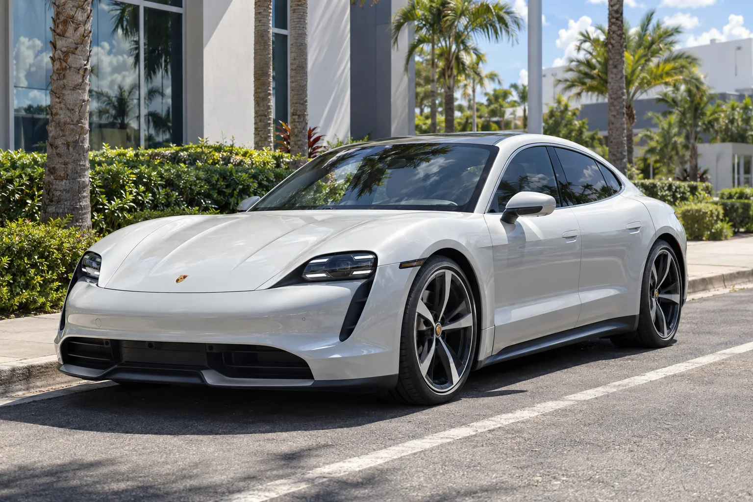 Pearl white Porsche Taycan with tinted windows at Dynamic Tinting Solution