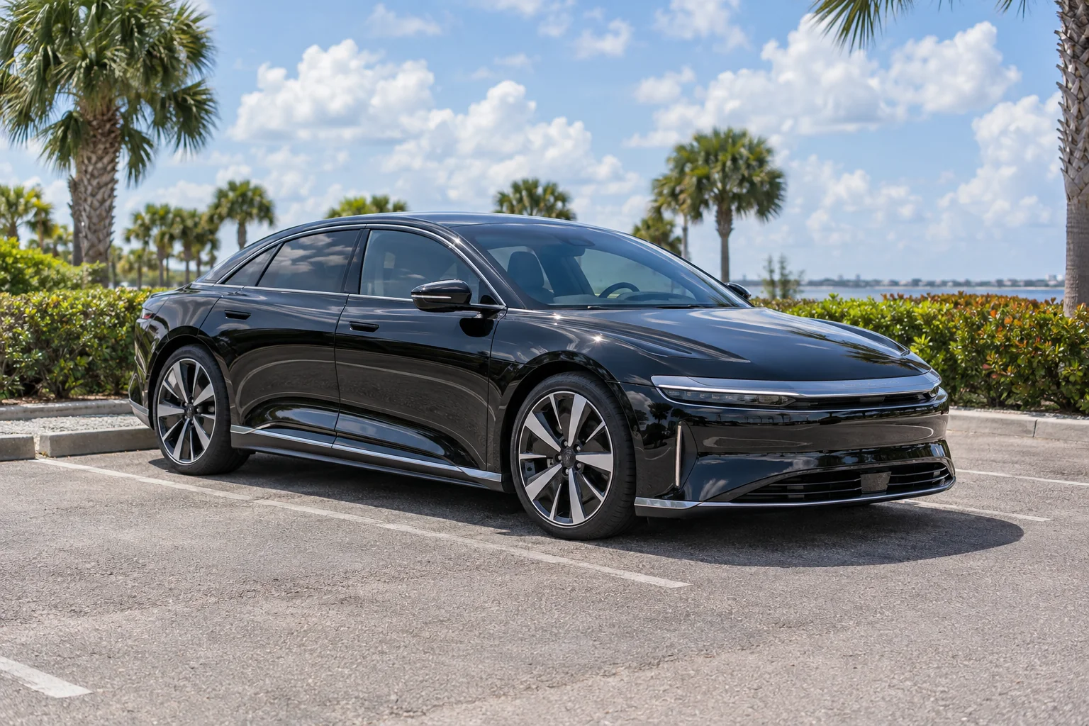 Gloss black Lucid Air sedan with tinted windows at Dynamic Tinting Solution