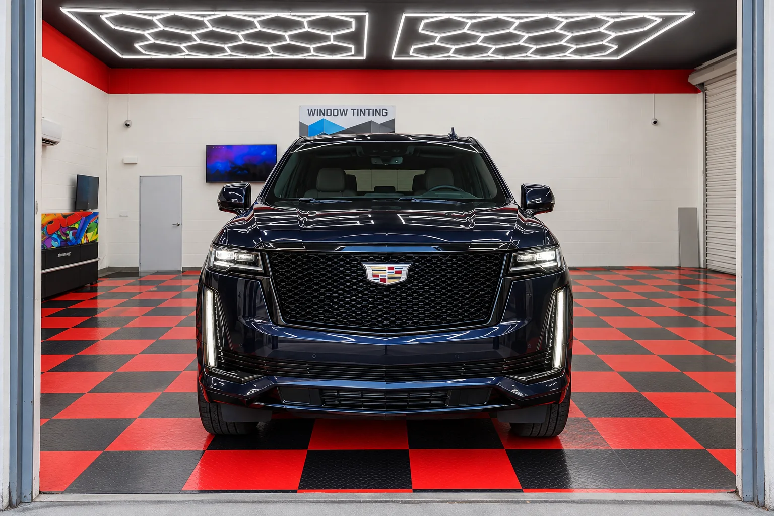 Deep navy blue metallic Cadillac Escalade with tinted windows at Dynamic Tinting Solution