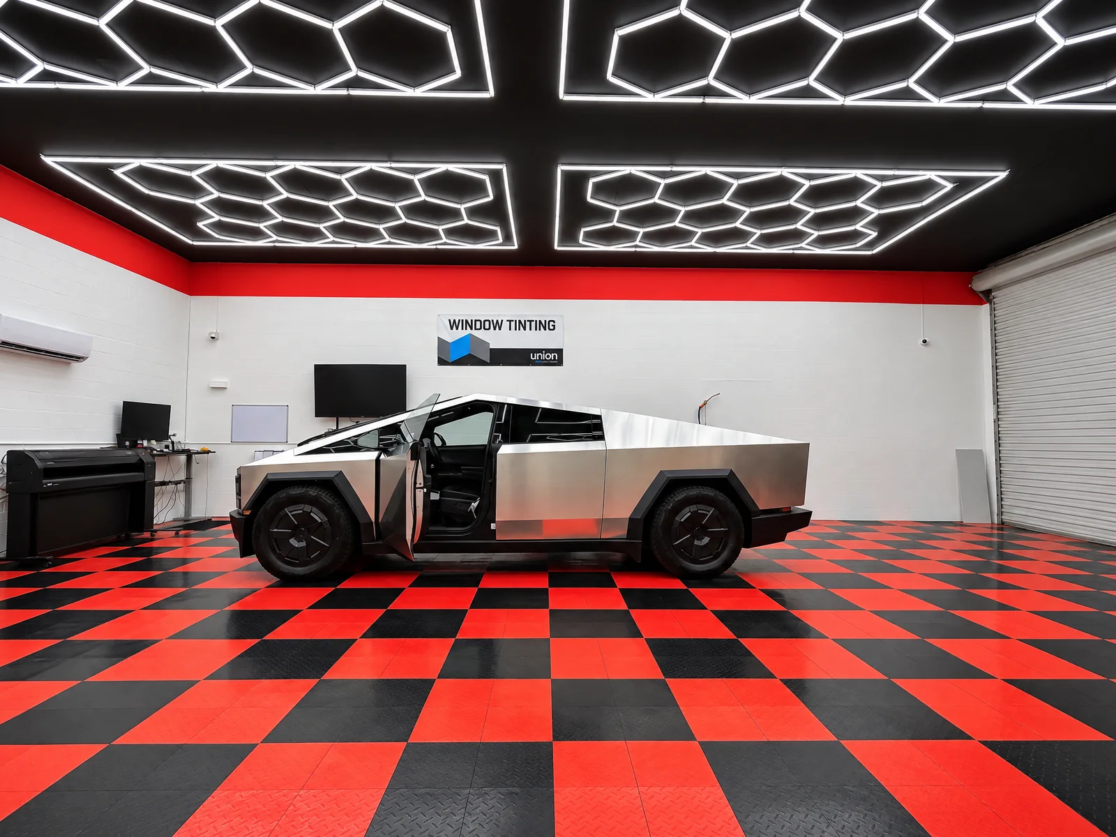 Stainless Tesla Cybertruck with tinted windows in the Dynamic Tinting Solution shop in Largo, FL