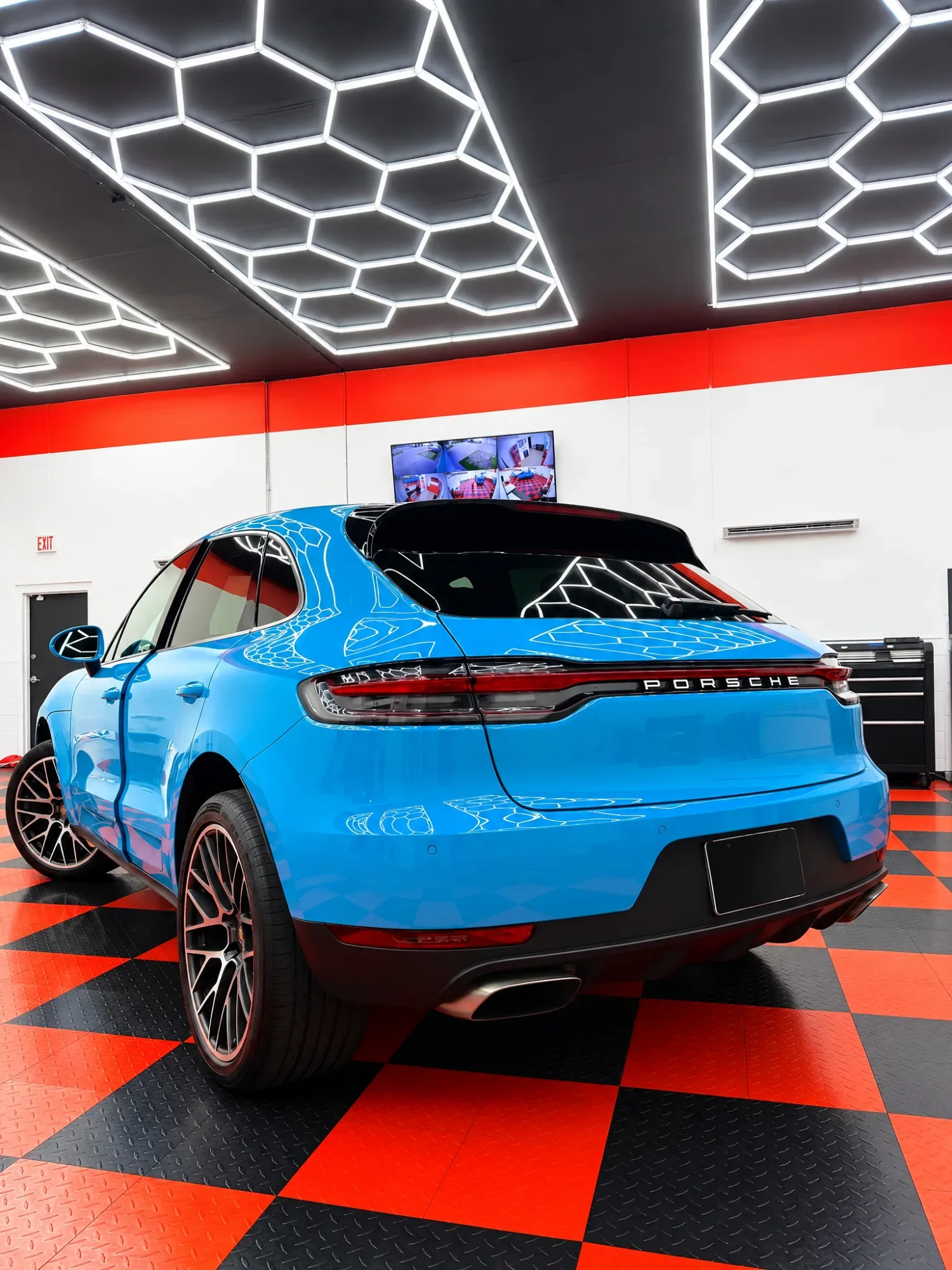 Blue Porsche Macan with tinted rear glass in the Dynamic Tinting Solution shop in Largo, FL